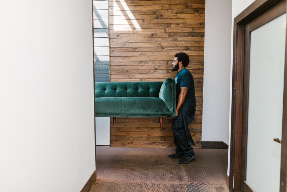 Movers carrying heavy furniture with care